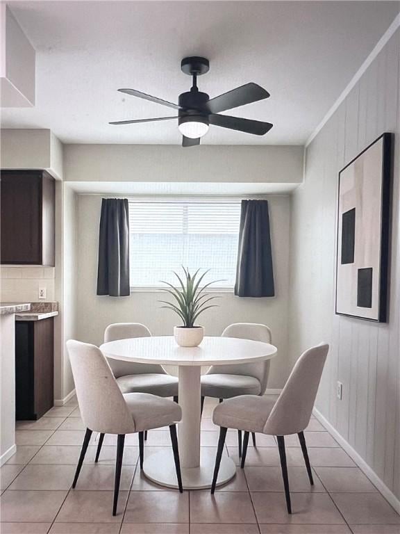 5825 San Saba Dr, Corpus Christi, TX 78407 - dining area featuring a ceiling fan, light tile patterned floors, and wood walls