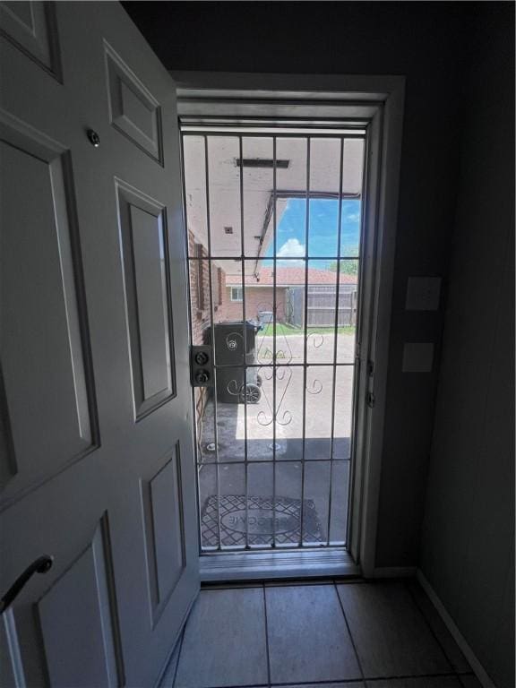 5825 San Saba Dr, Corpus Christi, TX 78407 - doorway with tile patterned flooring and baseboards