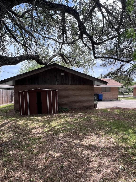 5825 San Saba Dr, Corpus Christi, TX 78407 - view of side of home featuring an outbuilding