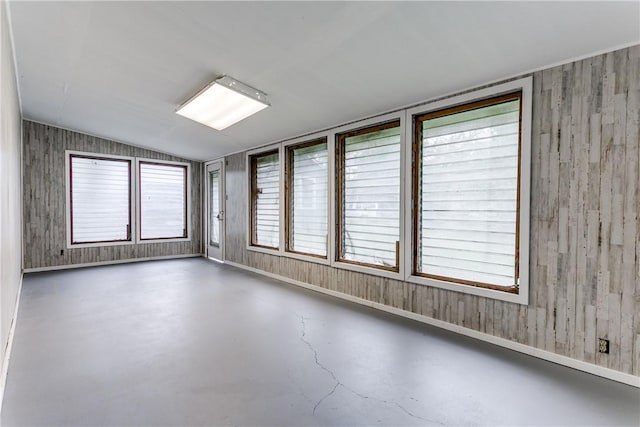 150 E Southcross Blvd, San Antonio, TX 78214 - empty room with finished concrete flooring, vaulted ceiling, wooden walls, and baseboards