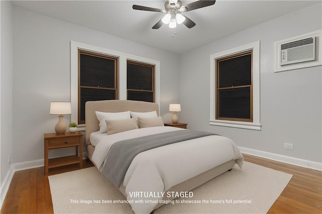 150 E Southcross Blvd, San Antonio, TX 78214 - bedroom with a wall mounted air conditioner, wood finished floors, baseboards, and a ceiling fan
