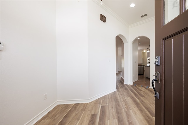 corridor with ornamental molding and wood-type flooring