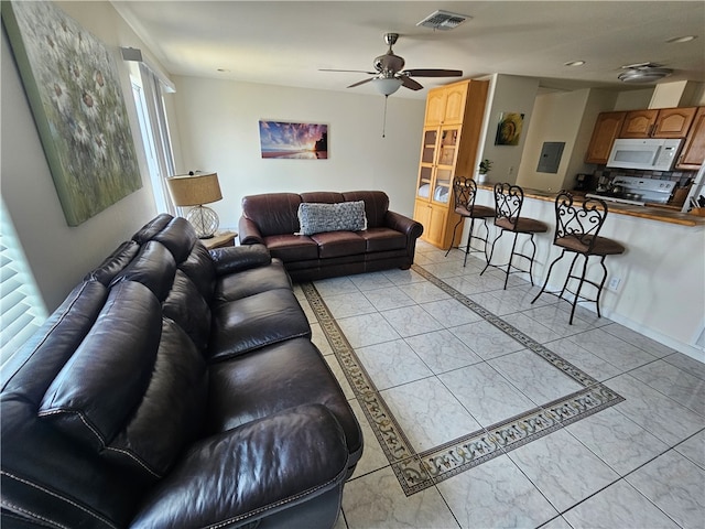 living room featuring a wealth of natural light and ceiling fan