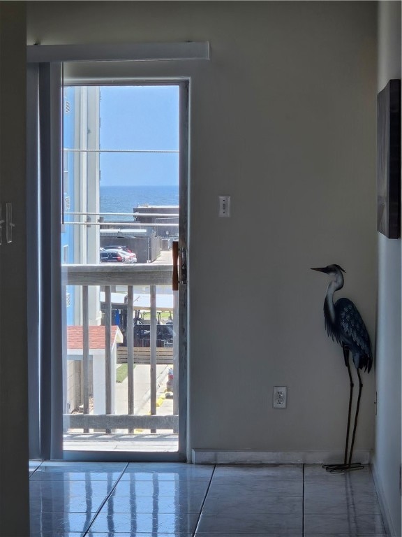 doorway to outside featuring a water view