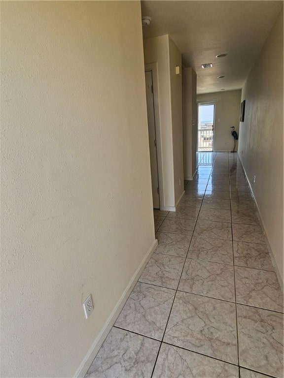 hall featuring light tile patterned flooring