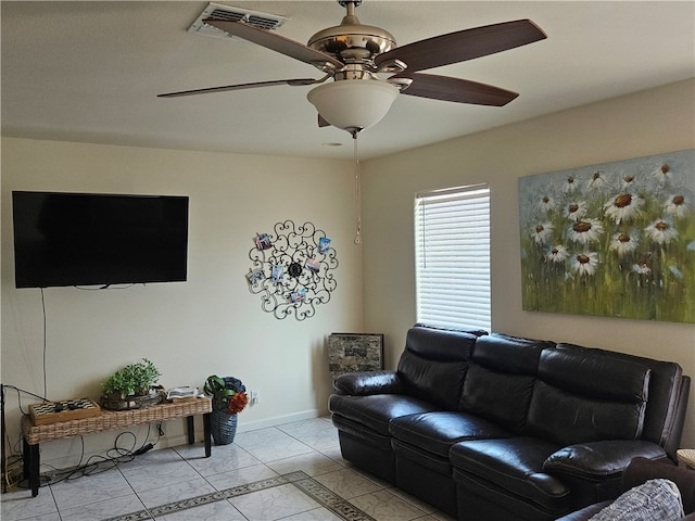 tiled living room with ceiling fan