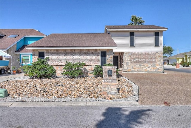 15317 Yardarm Ct, Corpus Christi, TX 78418 - view of front of house with stone siding and roof with shingles