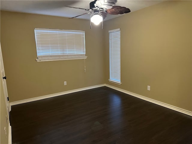 empty room featuring dark wood-type flooring and ceiling fan