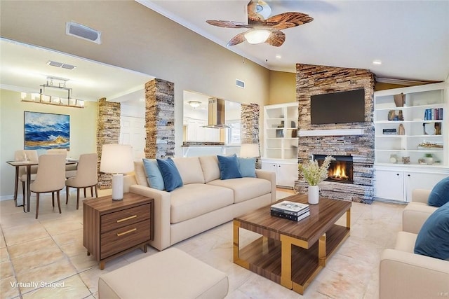 15317 Yardarm Ct, Corpus Christi, TX 78418 - living room with a ceiling fan, a stone fireplace, lofted ceiling, ornamental molding, and light tile patterned floors