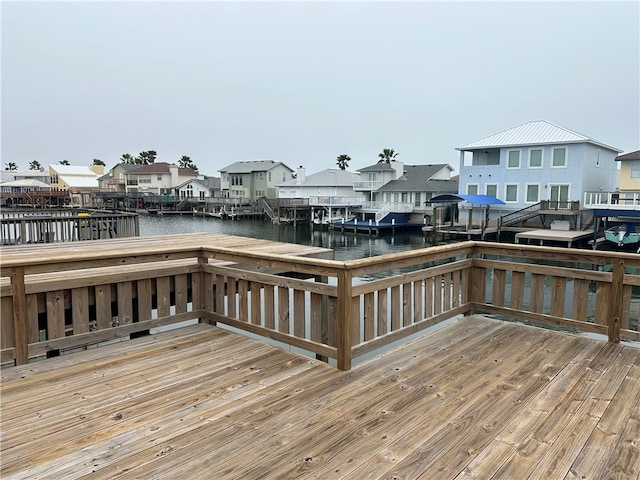 dock area featuring a deck with water view