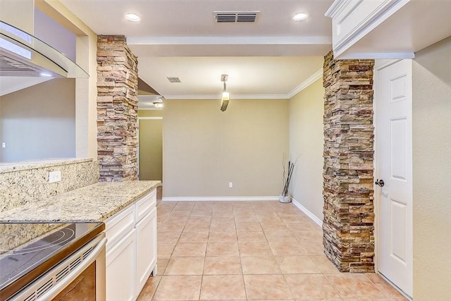 15317 Yardarm Ct, Corpus Christi, TX 78418 - kitchen with exhaust hood, white cabinets, crown molding, light stone countertops, and light tile patterned floors