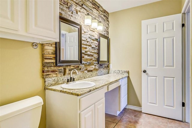 15317 Yardarm Ct, Corpus Christi, TX 78418 - bathroom with tile patterned flooring, vanity, and decorative backsplash