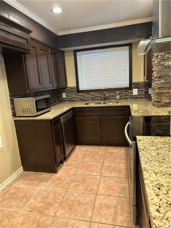 kitchen with light stone countertops, sink, ornamental molding, and stainless steel appliances