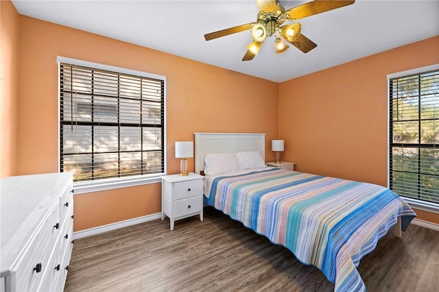 bedroom with baseboards, wood finished floors, and a ceiling fan