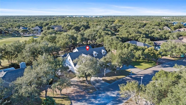 drone / aerial view featuring a wooded view