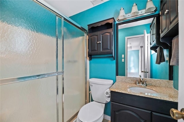 full bathroom featuring vanity, toilet, visible vents, and a stall shower