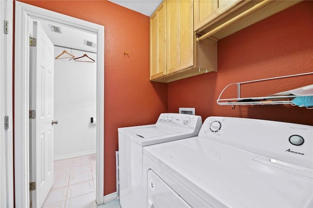 laundry room featuring cabinet space, visible vents, and washer and dryer