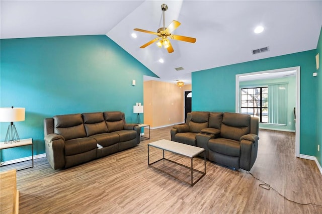 living area featuring a ceiling fan, wood finished floors, visible vents, high vaulted ceiling, and baseboards