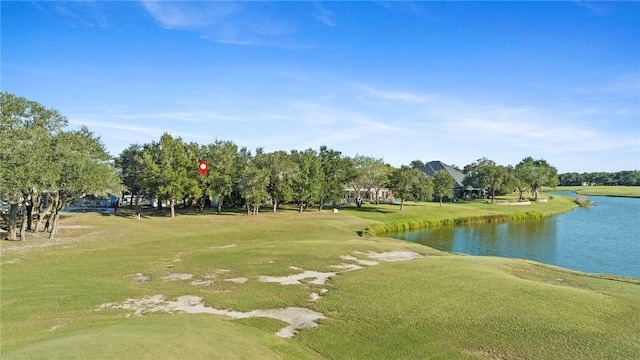 view of community with a lawn and a water view