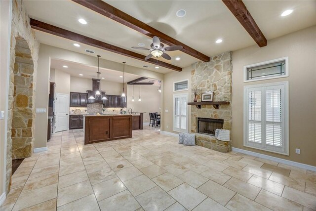 3722 Lake Hawkins Ct, Robstown, TX 78380 - kitchen with open floor plan, range hood, beamed ceiling, light countertops, and dark brown cabinets