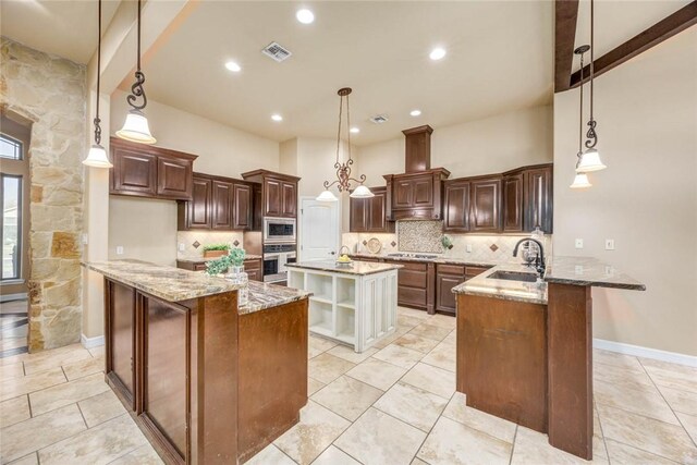 3722 Lake Hawkins Ct, Robstown, TX 78380 - kitchen featuring appliances with stainless steel finishes, a sink, a peninsula, an island with sink, and decorative backsplash