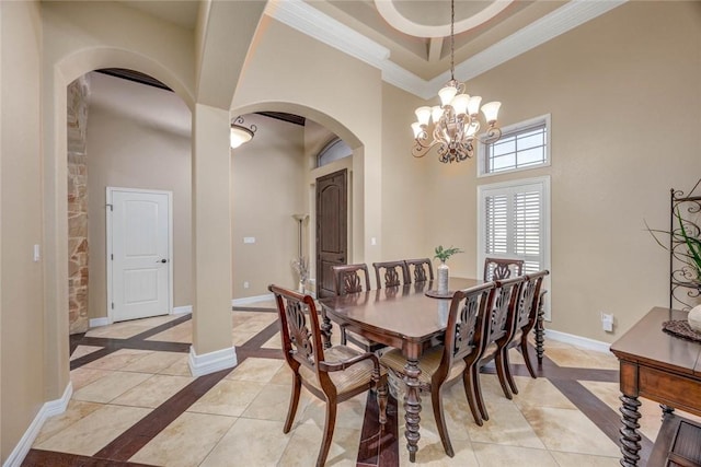 3722 Lake Hawkins Ct, Robstown, TX 78380 - dining room with inlaid floor details, arched walkways, a high ceiling, ornamental molding, and a chandelier