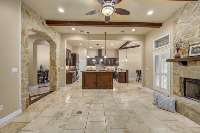3722 Lake Hawkins Ct, Robstown, TX 78380 - kitchen featuring open floor plan, ceiling fan, beamed ceiling, a kitchen island with sink, and a sink