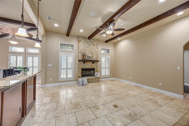 3722 Lake Hawkins Ct, Robstown, TX 78380 - unfurnished living room with beamed ceiling, a ceiling fan, a stone fireplace, baseboards, and recessed lighting