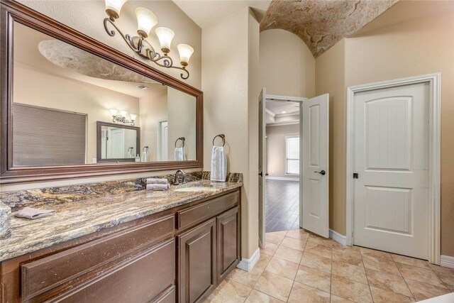 3722 Lake Hawkins Ct, Robstown, TX 78380 - bathroom with baseboards, vanity, tile patterned flooring, and a chandelier