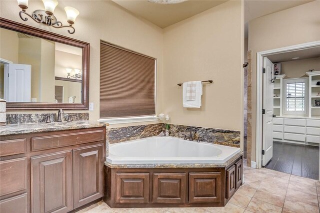 3722 Lake Hawkins Ct, Robstown, TX 78380 - bathroom with a garden tub, vanity, and a chandelier