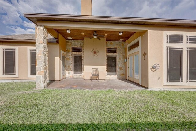 3722 Lake Hawkins Ct, Robstown, TX 78380 - rear view of property with stone siding, a patio area, a yard, and stucco siding