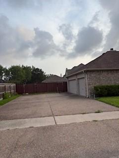 7502 Lourdes St, Corpus Christi, TX 78414 - view of home's exterior featuring an attached garage and driveway