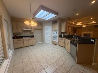 7502 Lourdes St, Corpus Christi, TX 78414 - kitchen with dishwasher, white double oven, a peninsula, dark countertops, and light tile patterned flooring