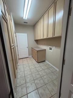 7502 Lourdes St, Corpus Christi, TX 78414 - washroom with cabinet space, hookup for a washing machine, and light tile patterned floors
