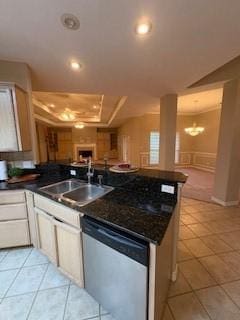 7502 Lourdes St, Corpus Christi, TX 78414 - kitchen featuring stainless steel dishwasher, light tile patterned floors, dark countertops, white cabinetry, and a chandelier