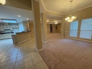 7502 Lourdes St, Corpus Christi, TX 78414 - kitchen with open floor plan, a chandelier, crown molding, carpet flooring, and decorative light fixtures