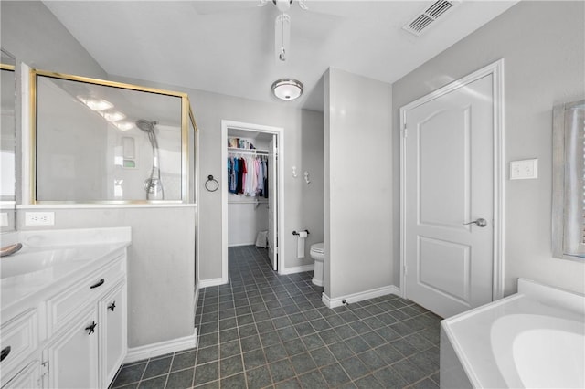 bathroom with tile patterned flooring, visible vents, a shower stall, toilet, and vanity