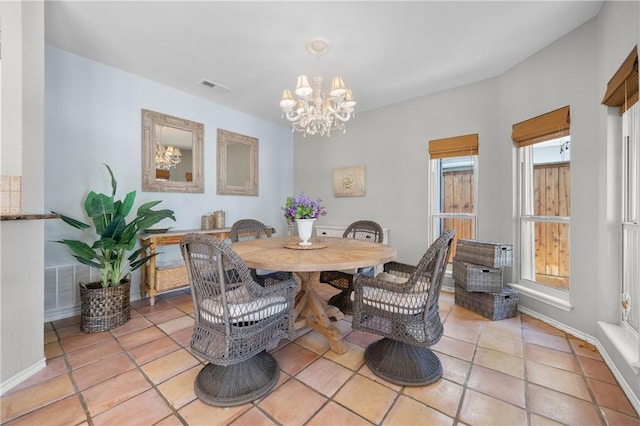 dining area with visible vents, baseboards, a notable chandelier, and light tile patterned flooring