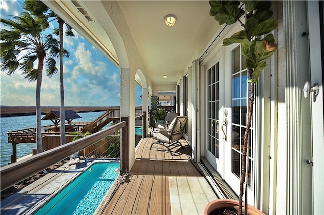 balcony with french doors and a water view