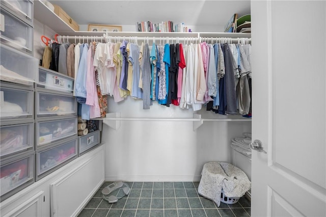 spacious closet with dark tile patterned flooring