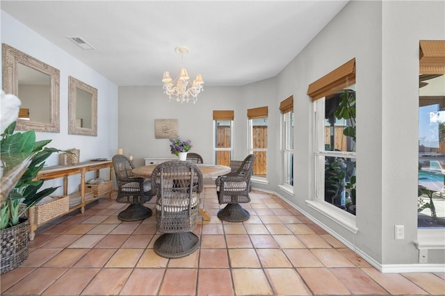 dining space with visible vents, plenty of natural light, a notable chandelier, and light tile patterned flooring