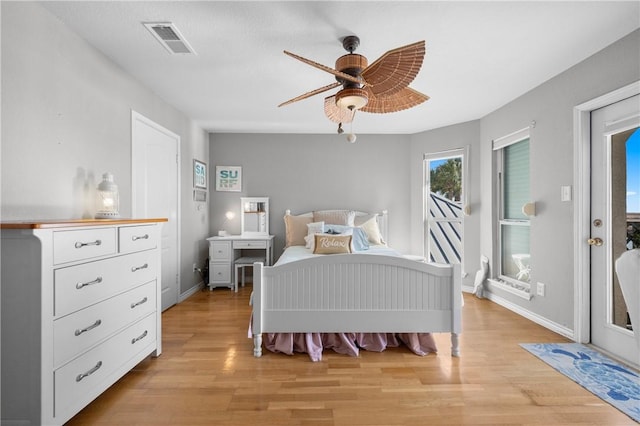 bedroom with visible vents, access to exterior, light wood finished floors, baseboards, and ceiling fan