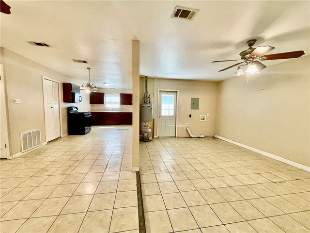 unfurnished living room with ceiling fan with notable chandelier, light tile patterned floors, and gas water heater