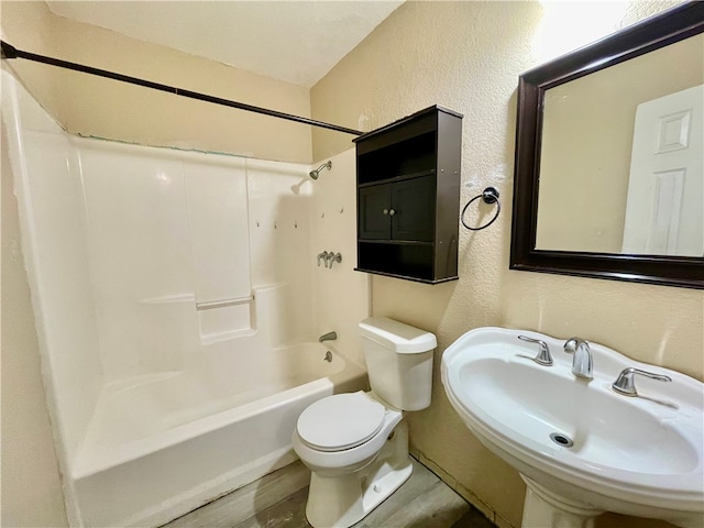 full bathroom with hardwood / wood-style floors, sink, toilet, and shower / bath combination