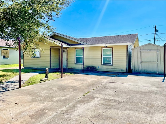 single story home with a front lawn and a storage unit