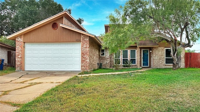 4026 Brownwood, Corpus Christi, TX 78410 - view of front of property featuring driveway, brick siding, and an attached garage