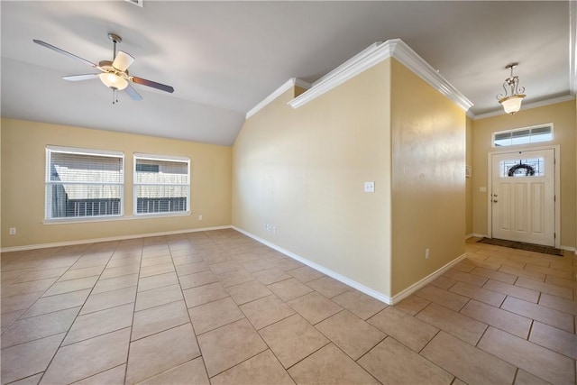 foyer entrance with ceiling fan, vaulted ceiling, ornamental molding, and light tile patterned floors