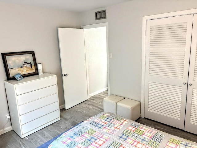 bedroom with hardwood / wood-style flooring and a closet