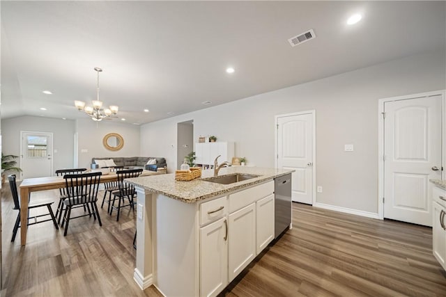 1142 Breebry Dr, Corpus Christi, TX 78415 - kitchen with stainless steel dishwasher, light wood finished floors, a chandelier, an island with sink, and pendant lighting