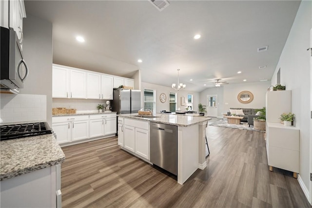 1142 Breebry Dr, Corpus Christi, TX 78415 - kitchen featuring stainless steel appliances, tasteful backsplash, wood finished floors, a kitchen island, and recessed lighting